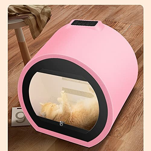 Cat sleeping inside a pink pet pod on a wooden floor.